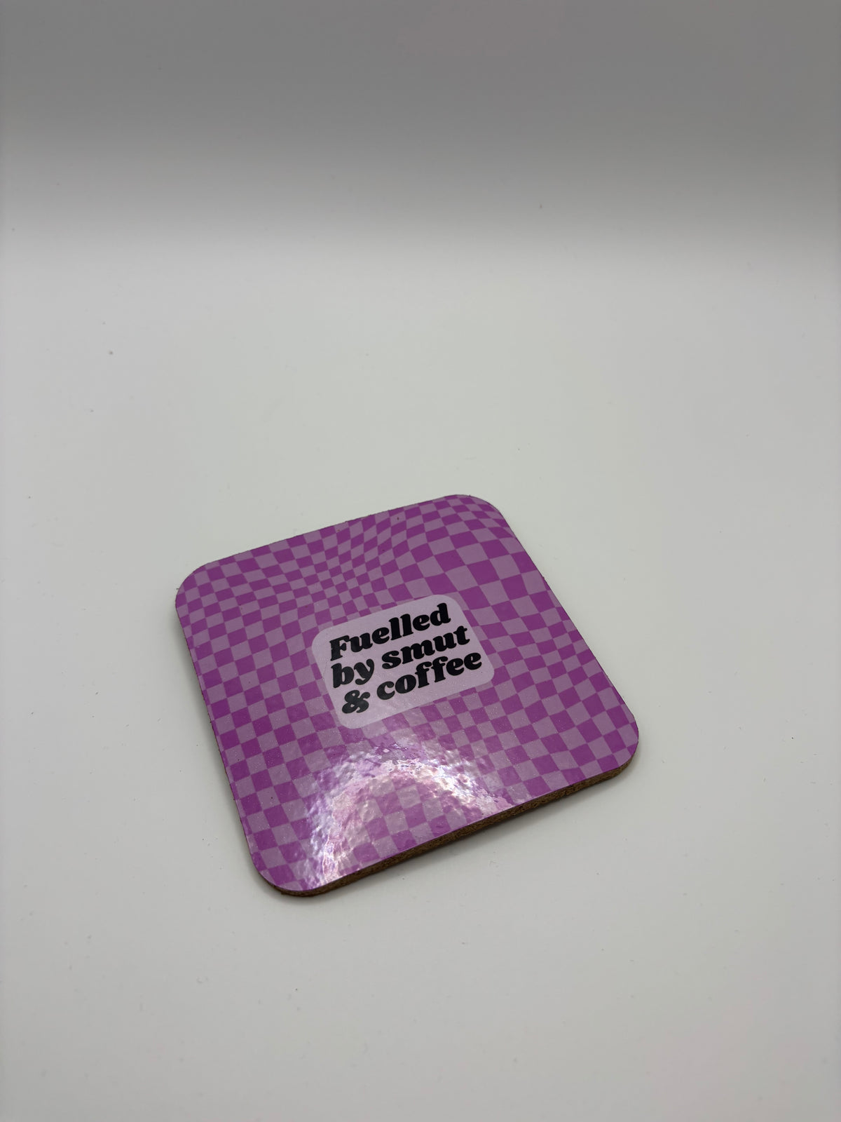 Fuelled by Smut & Coffee Cork Coaster – Purple Checkerboard